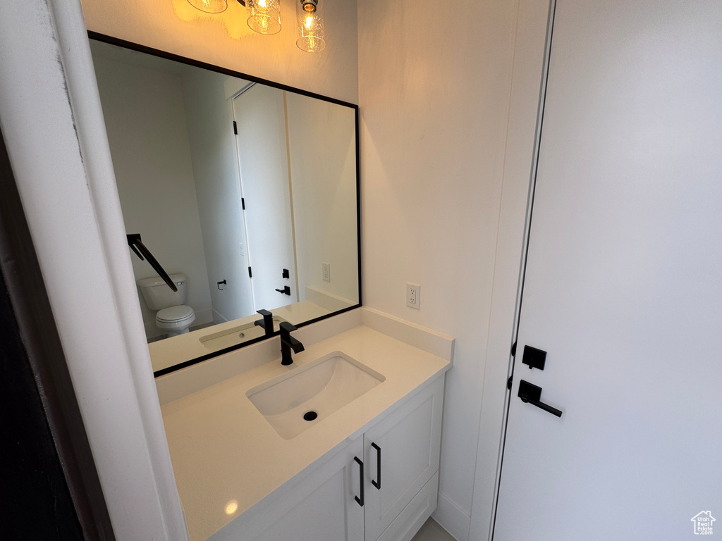 Bathroom featuring vanity and toilet