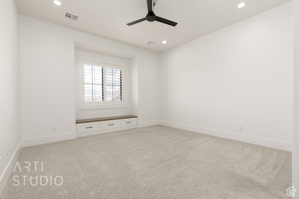 Spare room with recessed lighting, light colored carpet, ceiling fan, and baseboards