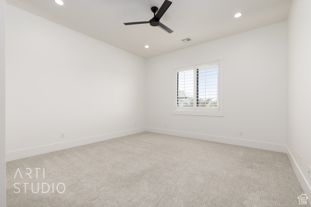 Carpeted empty room with a ceiling fan, recessed lighting, and baseboards