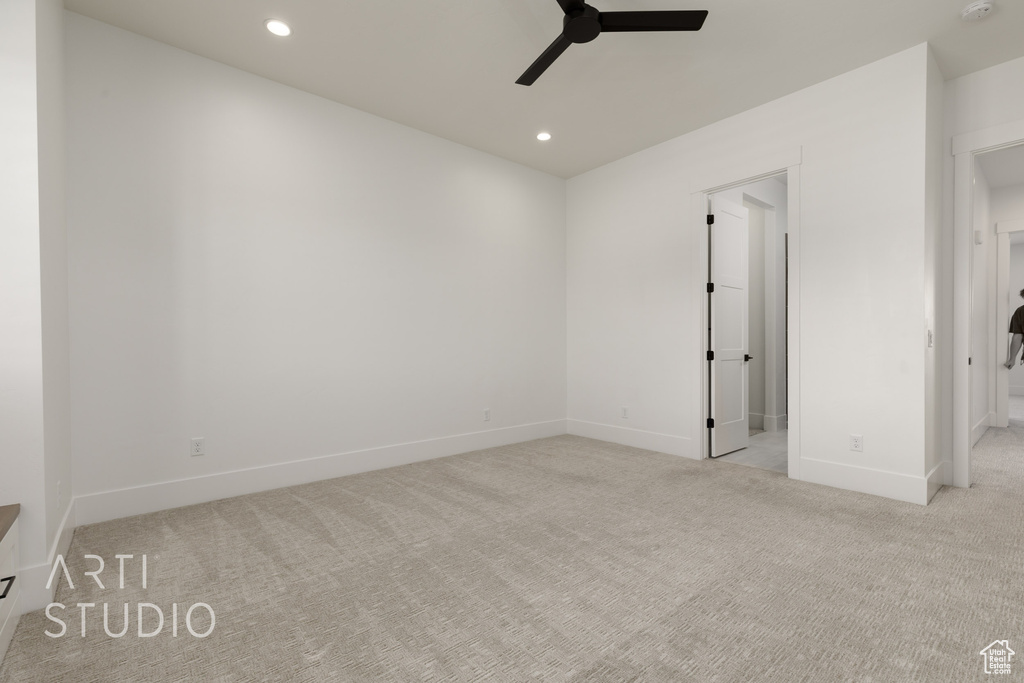 Carpeted spare room featuring a ceiling fan, recessed lighting, baseboards, and a smoke detector