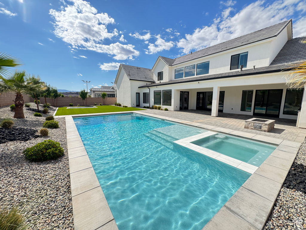 View of pool featuring a patio area and a pool with connected hot tub