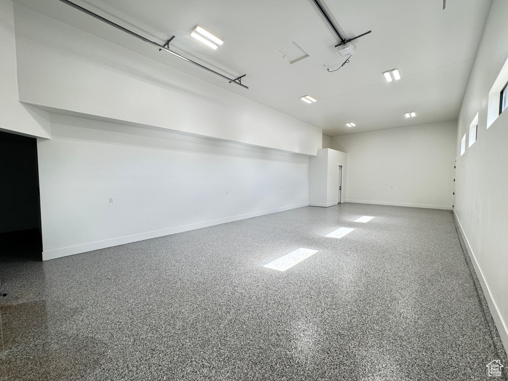 Spare room with baseboards and speckled floor