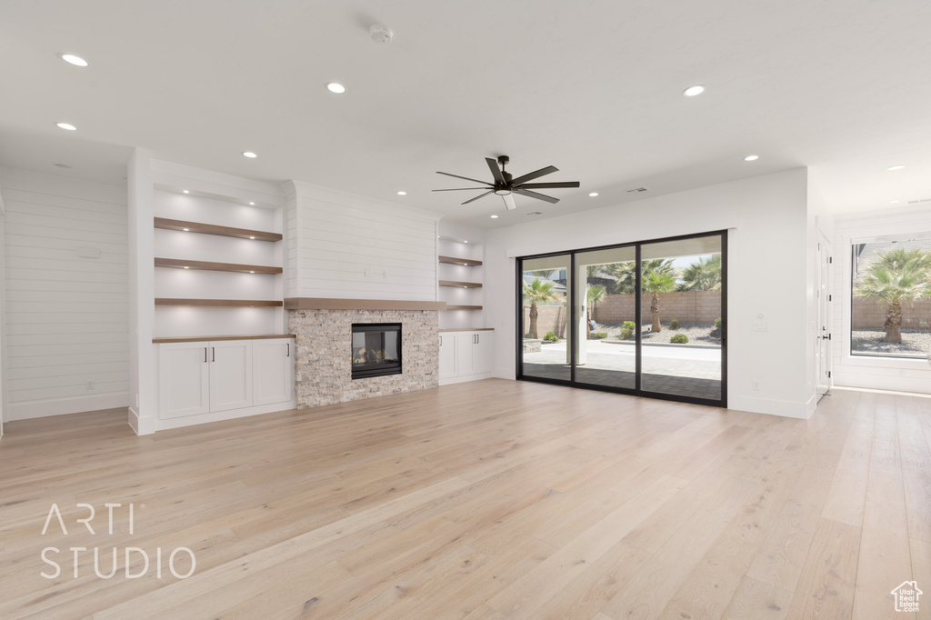 Unfurnished living room with recessed lighting, baseboards, light wood finished floors, built in features, and ceiling fan