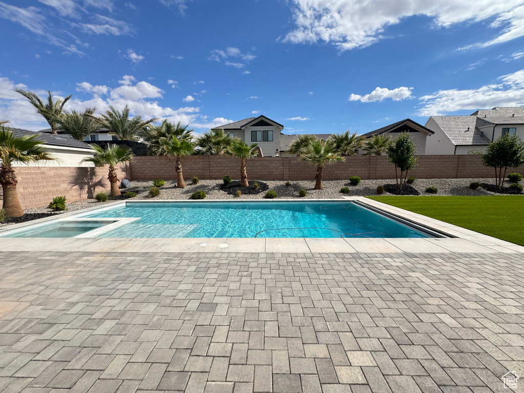 View of swimming pool with a fenced backyard and a patio area