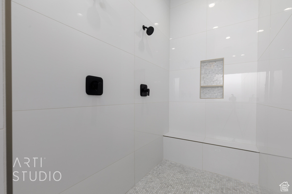 Bathroom featuring a tile shower and tile patterned flooring