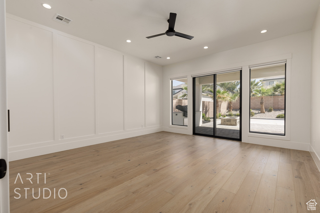 Unfurnished room with a decorative wall, light wood-type flooring, recessed lighting, and ceiling fan