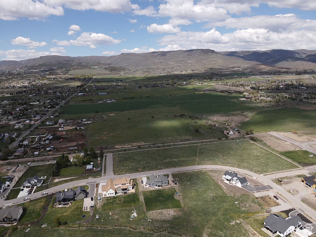 Aerial overview of property\\\'s location with a mountainous background and nearby suburban area
