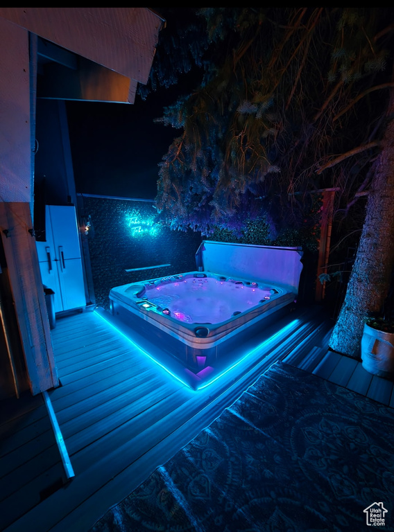 Pool at twilight with a covered hot tub