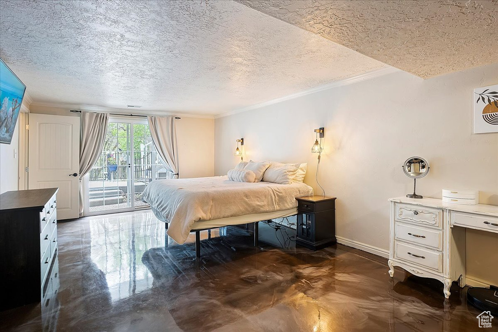 Bedroom featuring access to outside, ornamental molding, a textured ceiling, and baseboards