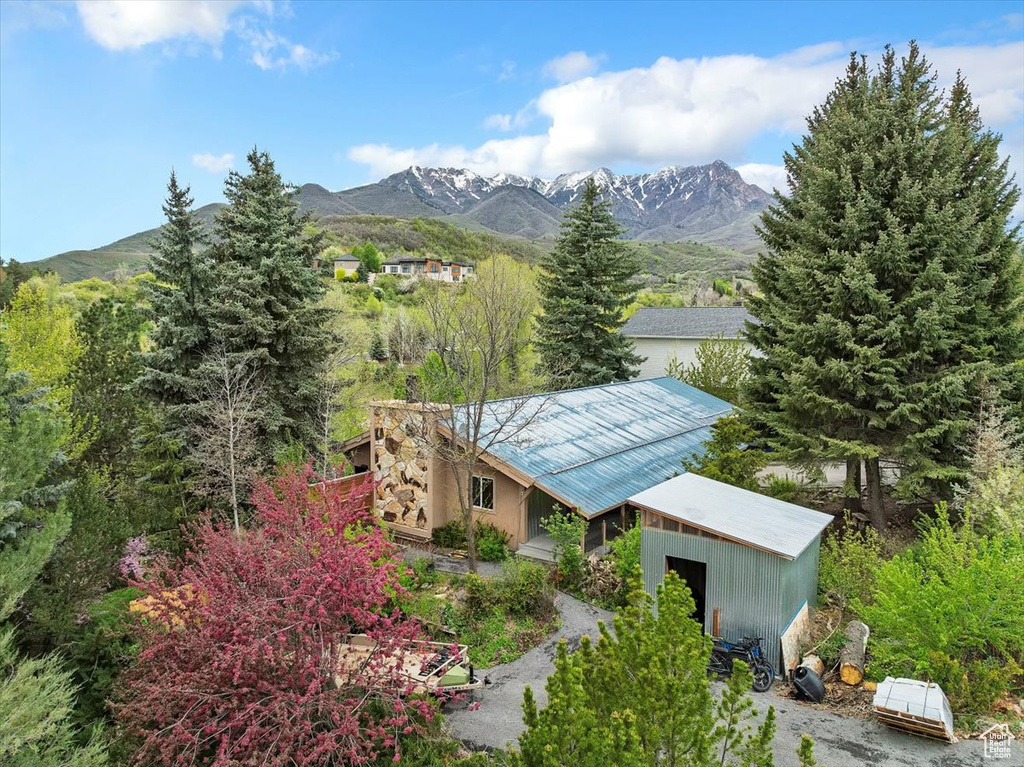 Aerial view of property and surrounding area with a mountain backdrop