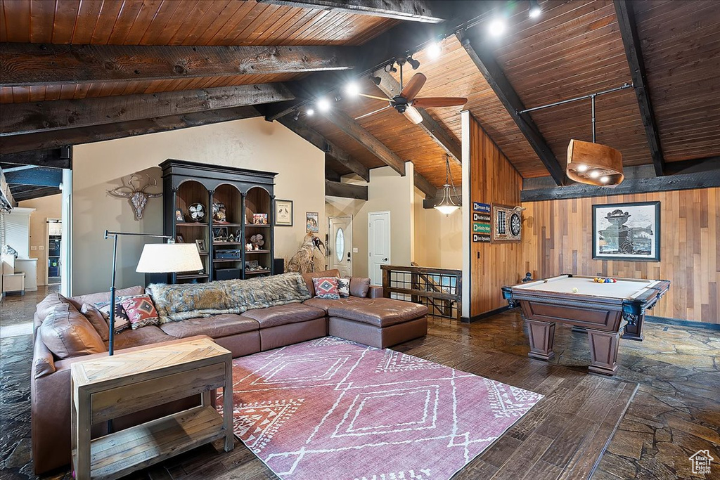 Living area with wooden ceiling, beam ceiling, wooden walls, ceiling fan, and wood finished floors