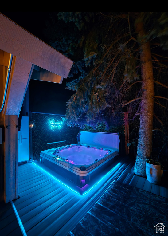Pool at twilight with a covered hot tub
