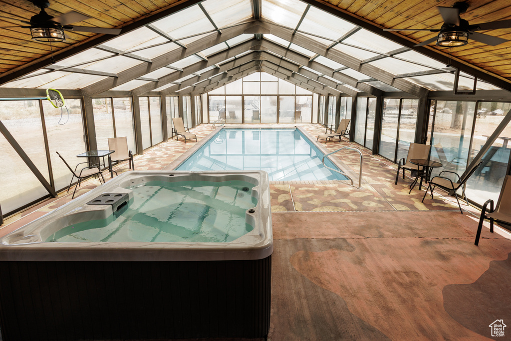 Indoor pool with an indoor hot tub and ceiling fan