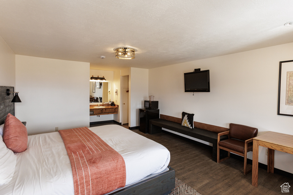 Bedroom featuring dark wood finished floors and baseboards