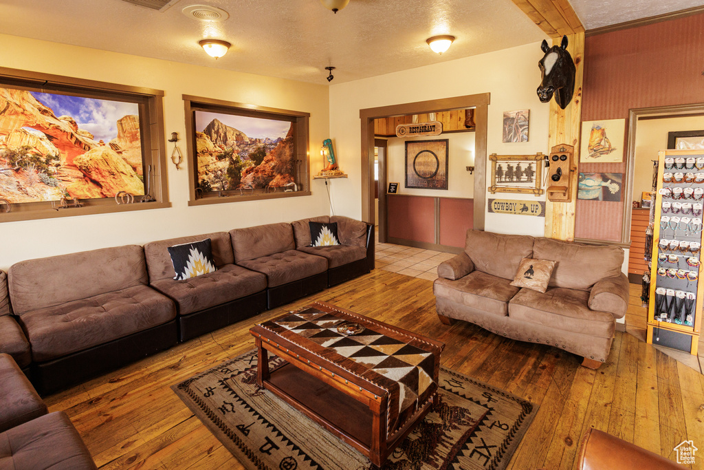 Living room featuring hardwood / wood-style floors and a textured ceiling