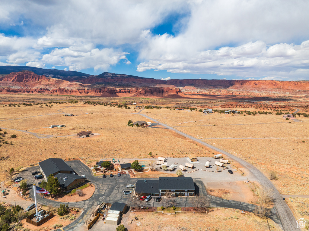 Aerial view of sparsely populated area featuring a mountain backdrop and a desert landscape