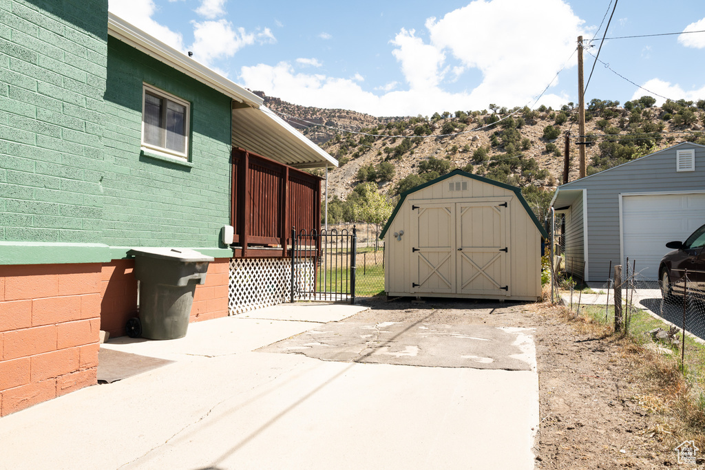 View of shed featuring fence and a mountain view
