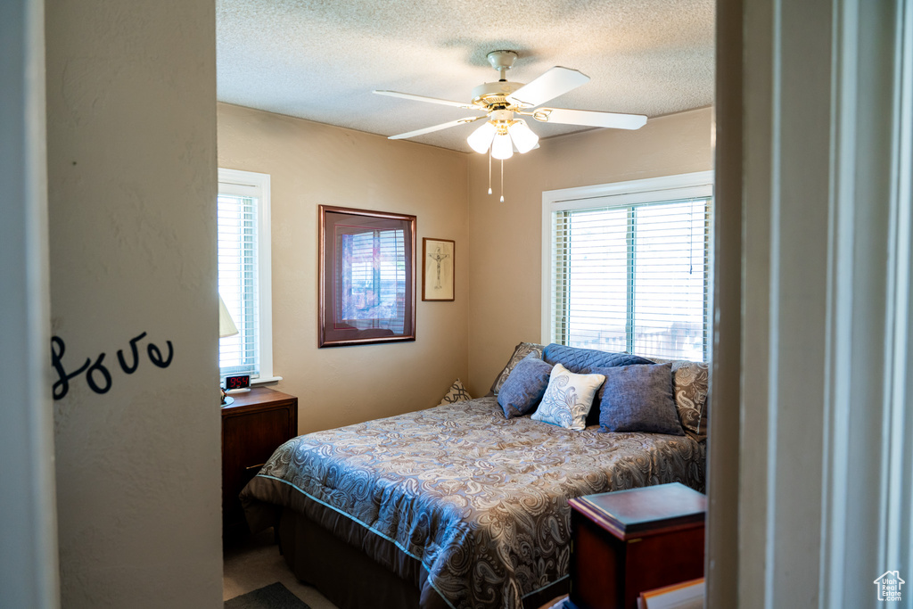 Bedroom featuring a textured ceiling and ceiling fan