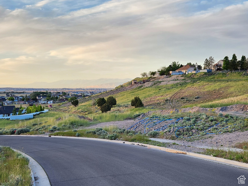 View of asphalt road with curbs