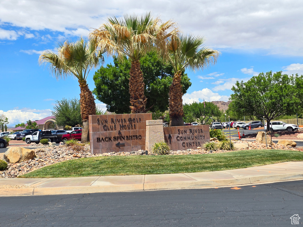 Community sign featuring uncovered parking