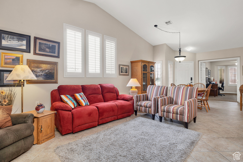 Living area featuring lofted ceiling and light tile patterned floors