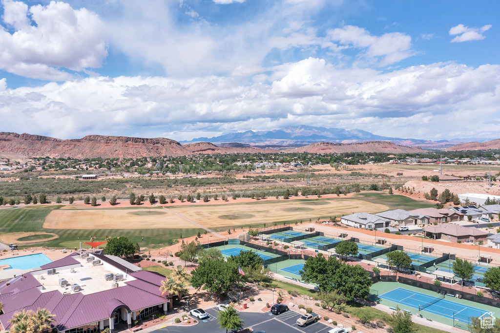 Drone / aerial view of a mountain backdrop and a local golf course