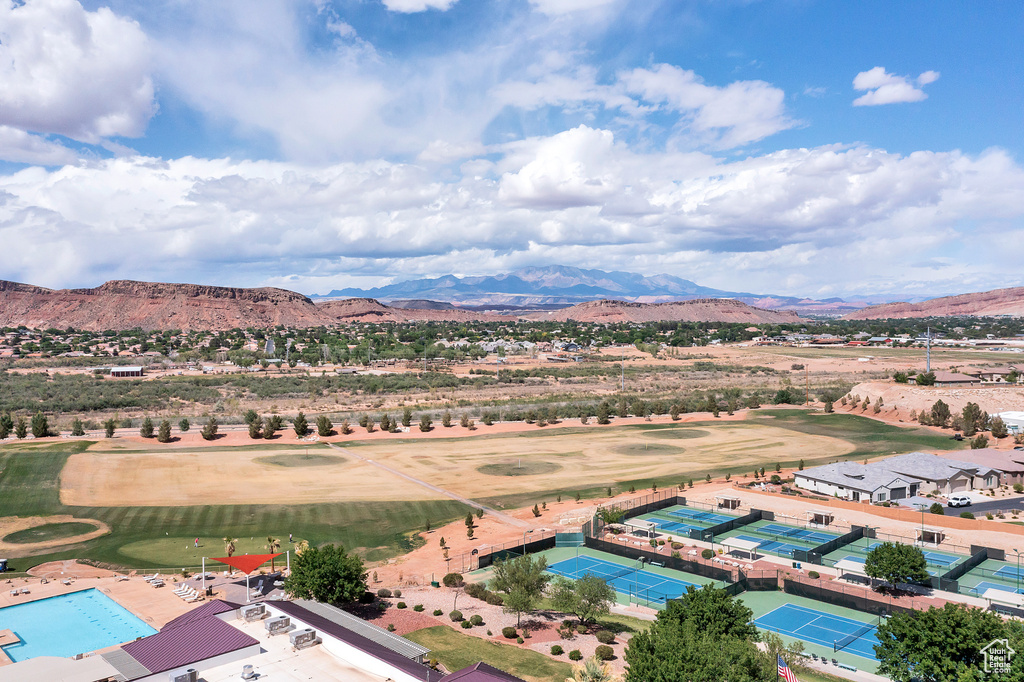 Aerial view of a mountainous background and a golf course