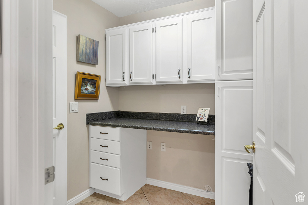 Unfurnished office with baseboards and light tile patterned floors