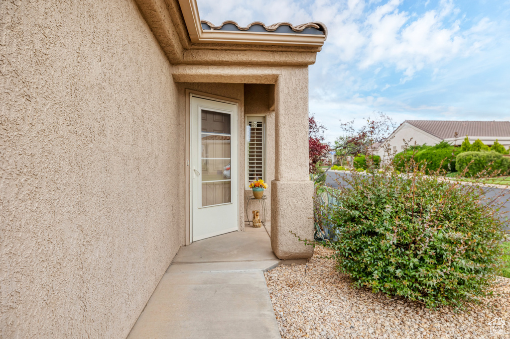 Entrance to property with stucco siding