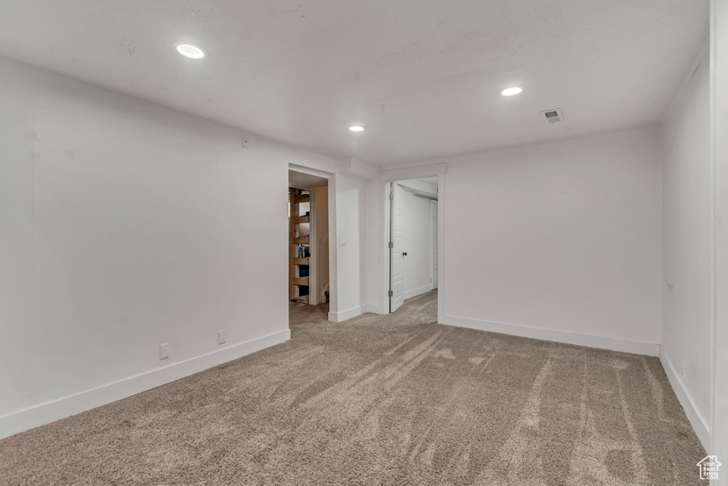 Empty room featuring recessed lighting, carpet, baseboards, and visible vents