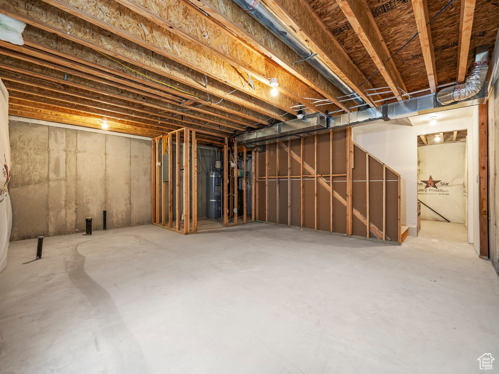 Unfinished below grade area featuring strapped water heater