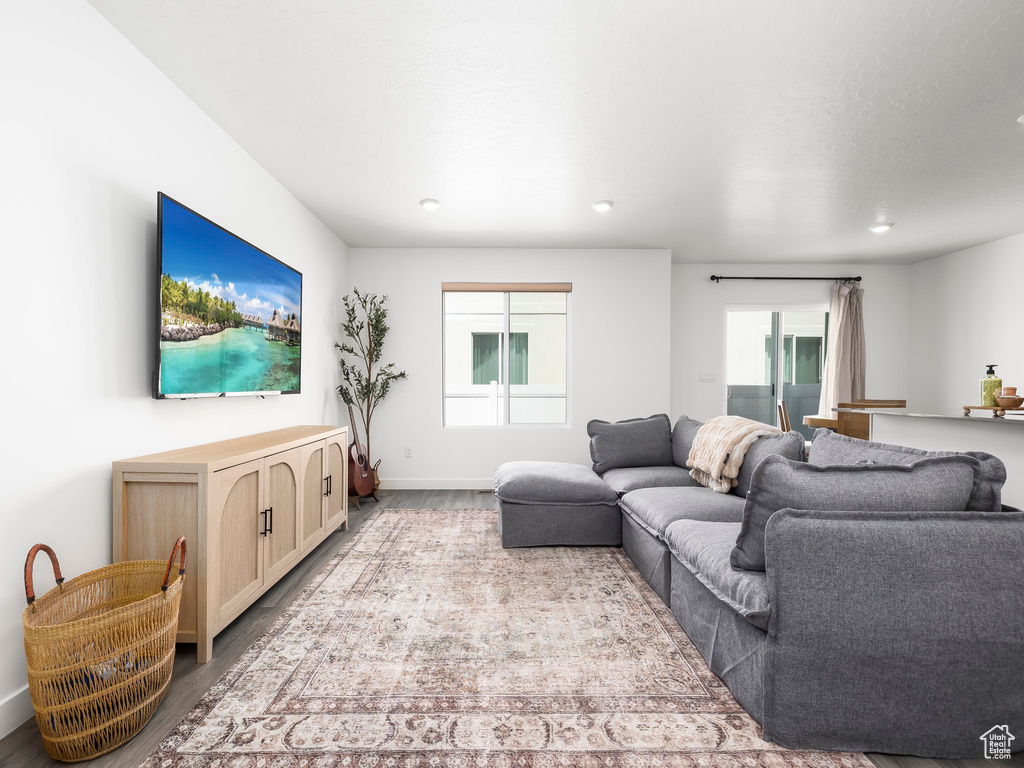 Living area featuring wood finished floors, recessed lighting, and baseboards