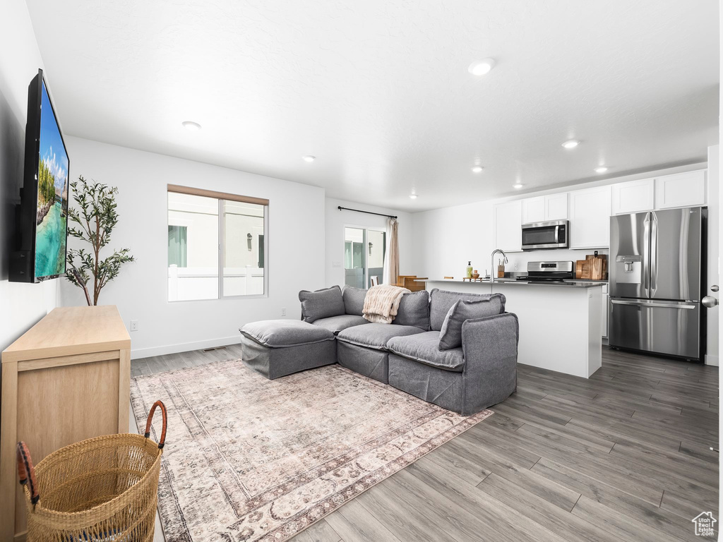 Living area featuring light wood finished floors and recessed lighting