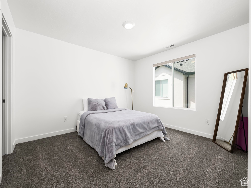 Carpeted bedroom with baseboards