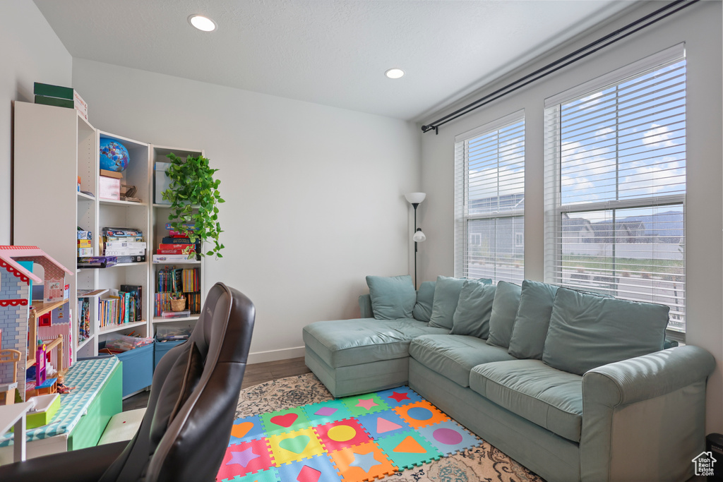 Office space with wood finished floors, baseboards, and recessed lighting