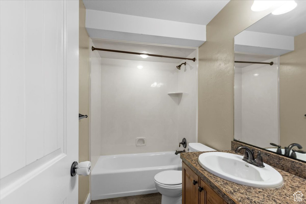 Bathroom with toilet, shower / washtub combination, and vanity