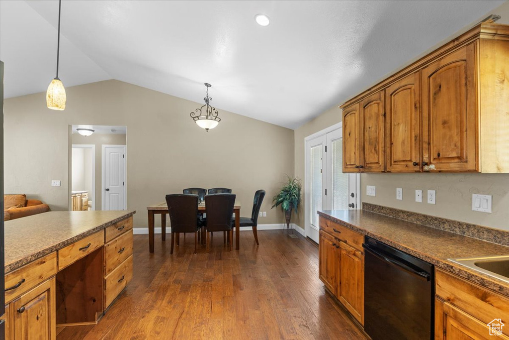 Kitchen featuring brown cabinetry, black dishwasher, hanging light fixtures, and vaulted ceiling