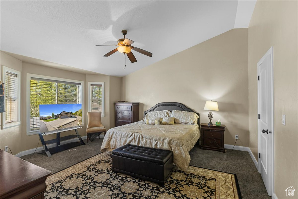 Bedroom featuring vaulted ceiling, baseboards, a ceiling fan, and carpet floors