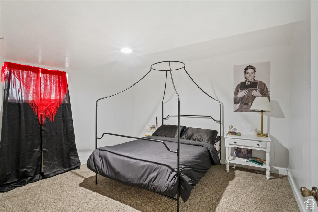 Carpeted bedroom featuring baseboards