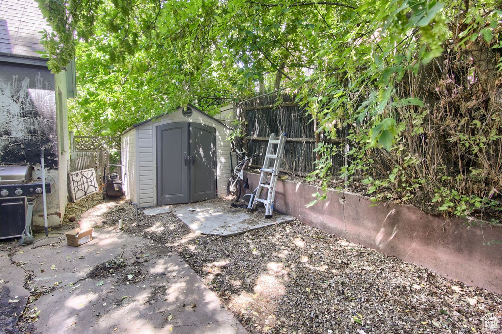View of shed featuring fence