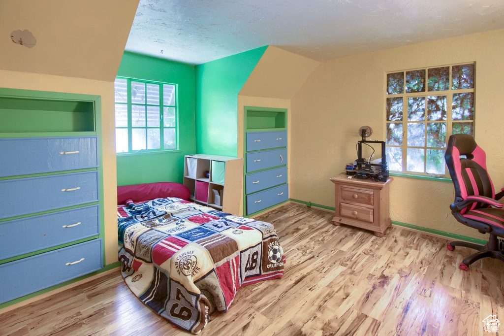 Bedroom featuring wood finished floors and baseboards
