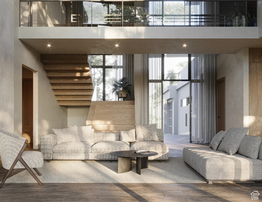 Living room featuring a towering ceiling and wood finished floors