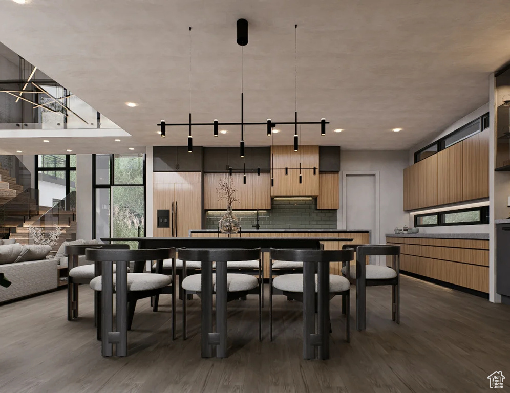 Dining area featuring wood finished floors, expansive windows, stairs, and recessed lighting