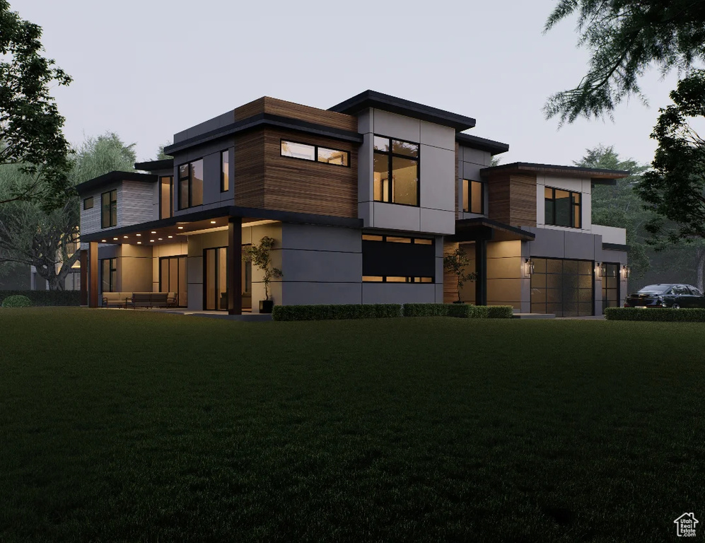 View of front of home with a front yard and stucco siding