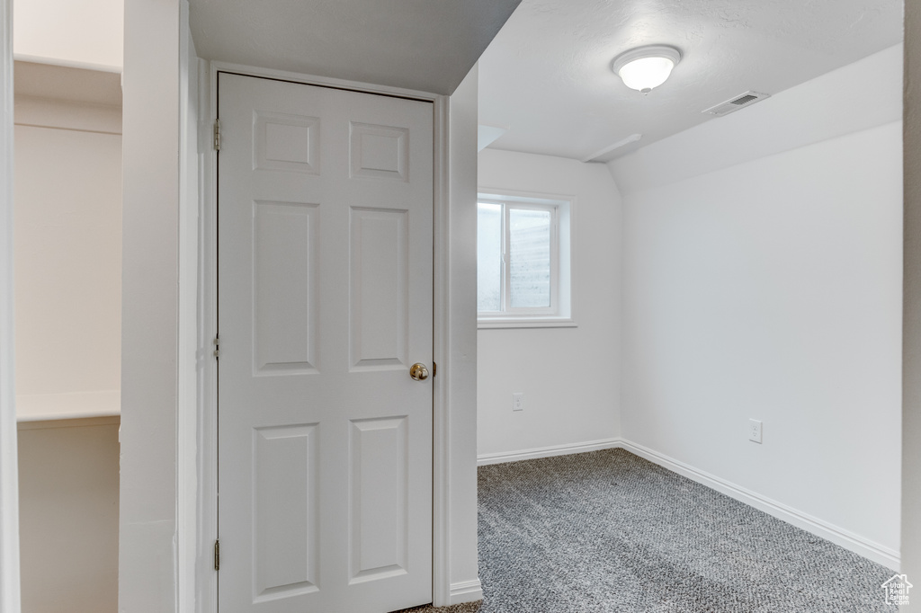 Spare room with carpet and baseboards