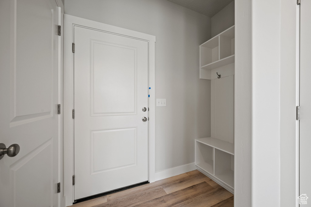 Mudroom with light wood-style floors and baseboards