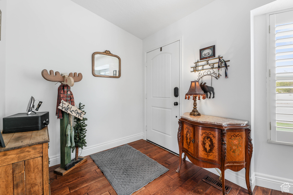 Entryway featuring wood-type flooring, baseboards, and visible vents