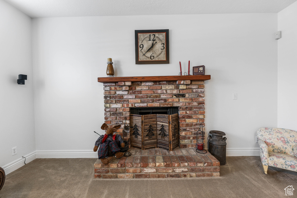 Interior details with baseboards, a fireplace, and carpet
