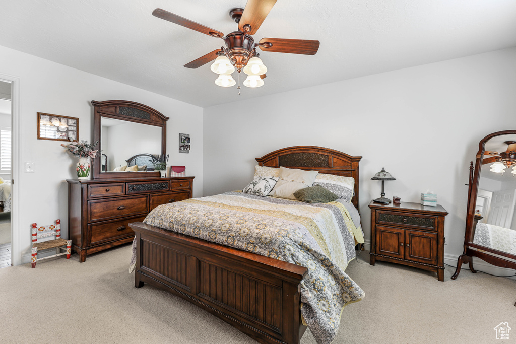 Bedroom featuring light colored carpet and ceiling fan