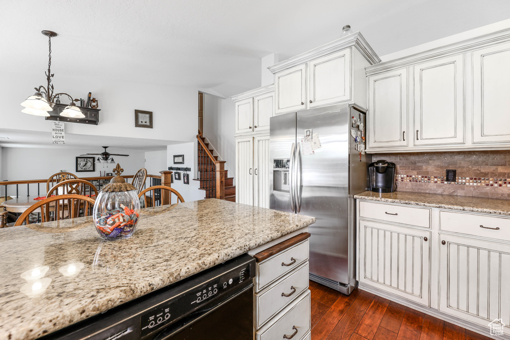Kitchen featuring dishwasher, ceiling fan, stainless steel refrigerator with ice dispenser, dark wood-type flooring, and tasteful backsplash